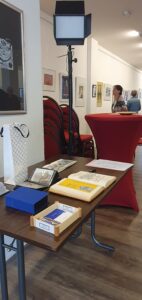 Ein Tisch mit einem Gästebuch und Skizzenbücher der Künstlerin.