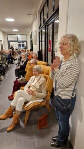 Gäste der Vernissage, im Vordergrund eine Frau.